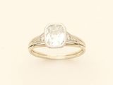 an engagement ring with a cushion cut diamond set in 18k yellow gold