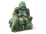 une image représentant la statue d'un homme assis au sommet d'un tas de feuilles