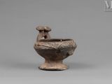 an image of a brown vase with a bird on it