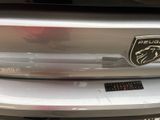a close up of a car with a badge on it ' s bumper