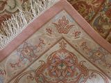 a close up of a rug with a flower design on it