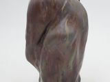 a brown vase with a bird on it