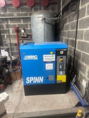 a small blue machine that is sitting in a garage