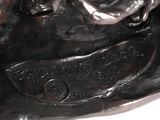 bronze statue of a dog with a ball in its mouth and a ball in its mouth