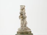 marble statue of a woman holding a child on a pedestal