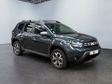 a picture of a grey dacia parked in a showroom