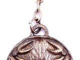 a silver keychain with a flower design on it