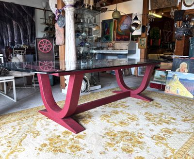 a red table with a glass top in a room