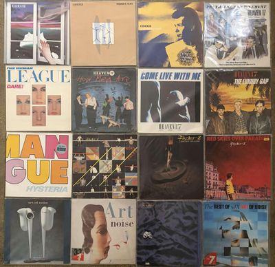 many different album covers on the wall of a room
