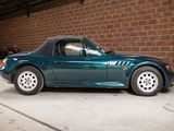 a green sports car parked in a garage