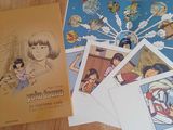 a lot of books on the table with pictures on them
