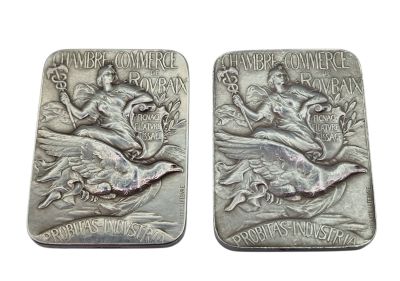 pair of two silver coin with a woman and a bird on it