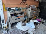 a picture of a garage with a lot of junk on the floor