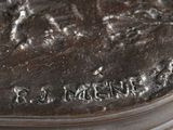 a close up of a bronze statue of a horse