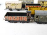 several toy trains are lined up in a row on a white surface