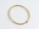 a close up of a gold ring on a white surface