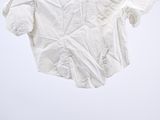 an image of a white shirt hanging on a clothes hanger