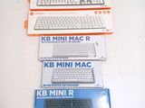 three boxes of keyboards sitting on a white table
