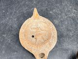 a piece of pottery on the table next to a frying pan