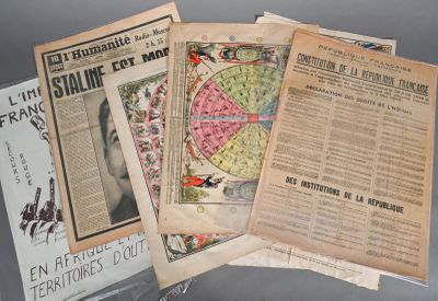 several old newspapers are stacked on top of each other on a table
