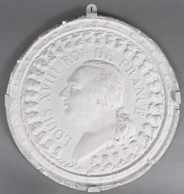 an image of a white medallion with a man ' s face on it