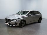 a silver car parked in a room with a white wall