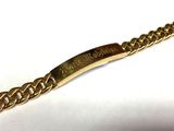 an image of a gold chain bracelet with a name engraved on it