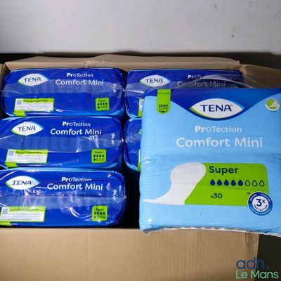 several packs of tena comfort minis in a cardboard box