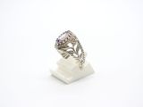 a close up of a ring on a stand with a white background