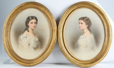 two framed portraits of a woman and a man in formal dress