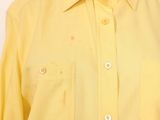 a close up of a man wearing a yellow shirt