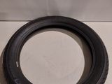 a tire on a white surface with a white wall in the background