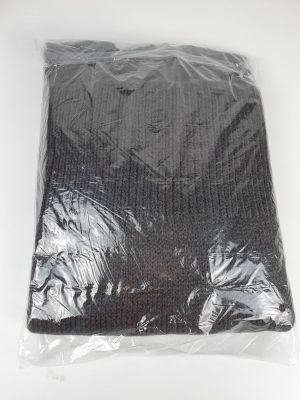 a close up of a bag of black clothing on a white surface