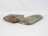 two pieces of rock on a white surface with a white background
