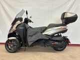 a picture of a black and silver motorcycle parked in a garage