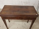 a small wooden table with a drawer on top of it