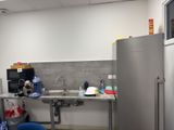 an image of a kitchen with a sink and a refrigerator