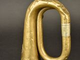 an old brass trumpet with a brass handle on a black background