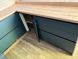 an image of a kitchen with a wooden counter top and blue cabinets