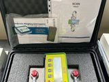 a green and yellow device in a case on a table