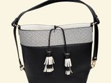 black and white handbag with tassels hanging from the handle
