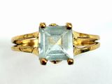 an image of a gold ring with an aquamarine stone