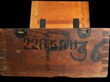 a wooden box with a sign on it on a black background