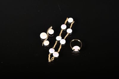 un gros plan sur une paire de bagues et une bague posée sur une surface noire