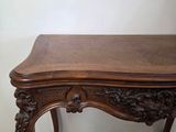 an image of a wooden table with carvings on the top