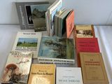 a lot of books that are on a bed