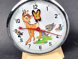 a clock with a picture of a deer and a butterfly on it
