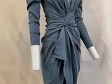 the mannequin is wearing a gray dress with long sleeves