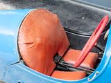 a blue car with a red seat and a red handle