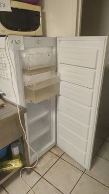 a white refrigerator with its door open in a kitchen